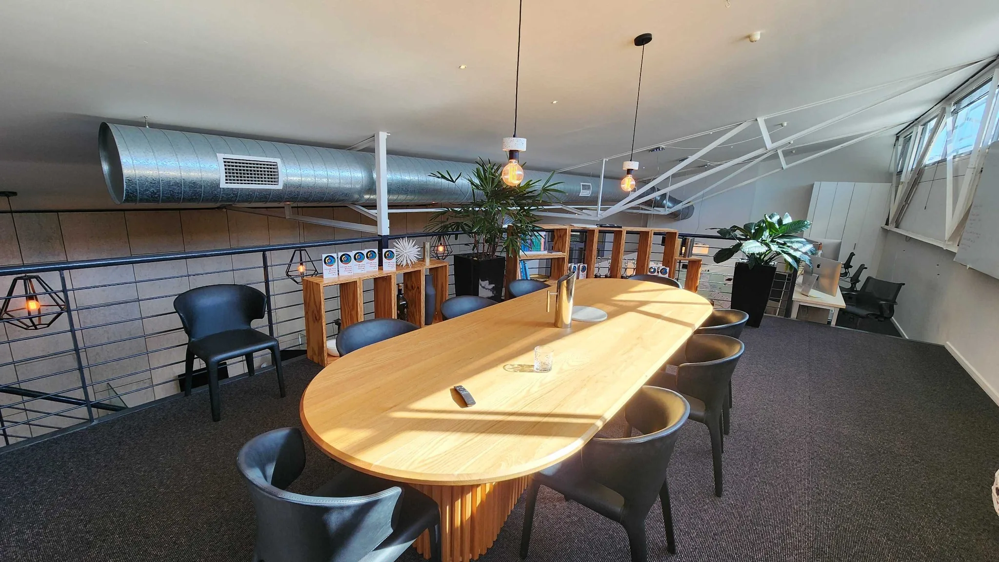Boardroom table under the pitched roof on the mezzanine.