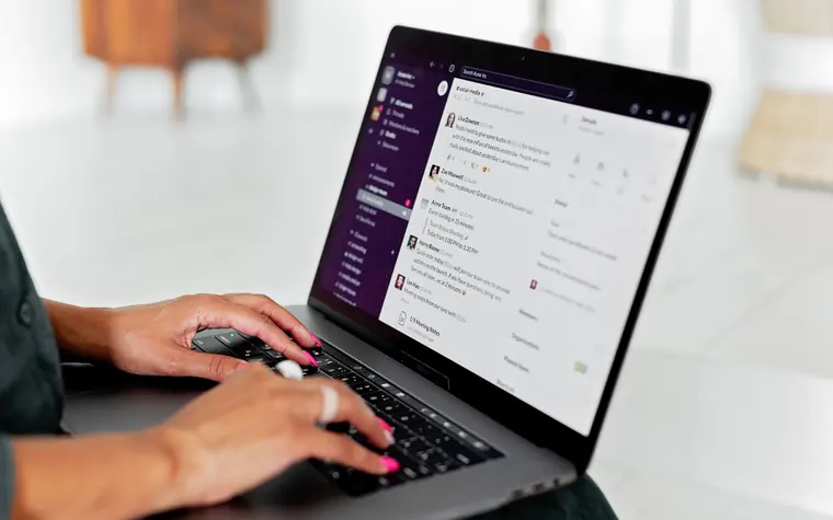 Person working through an email inbox on a laptop.