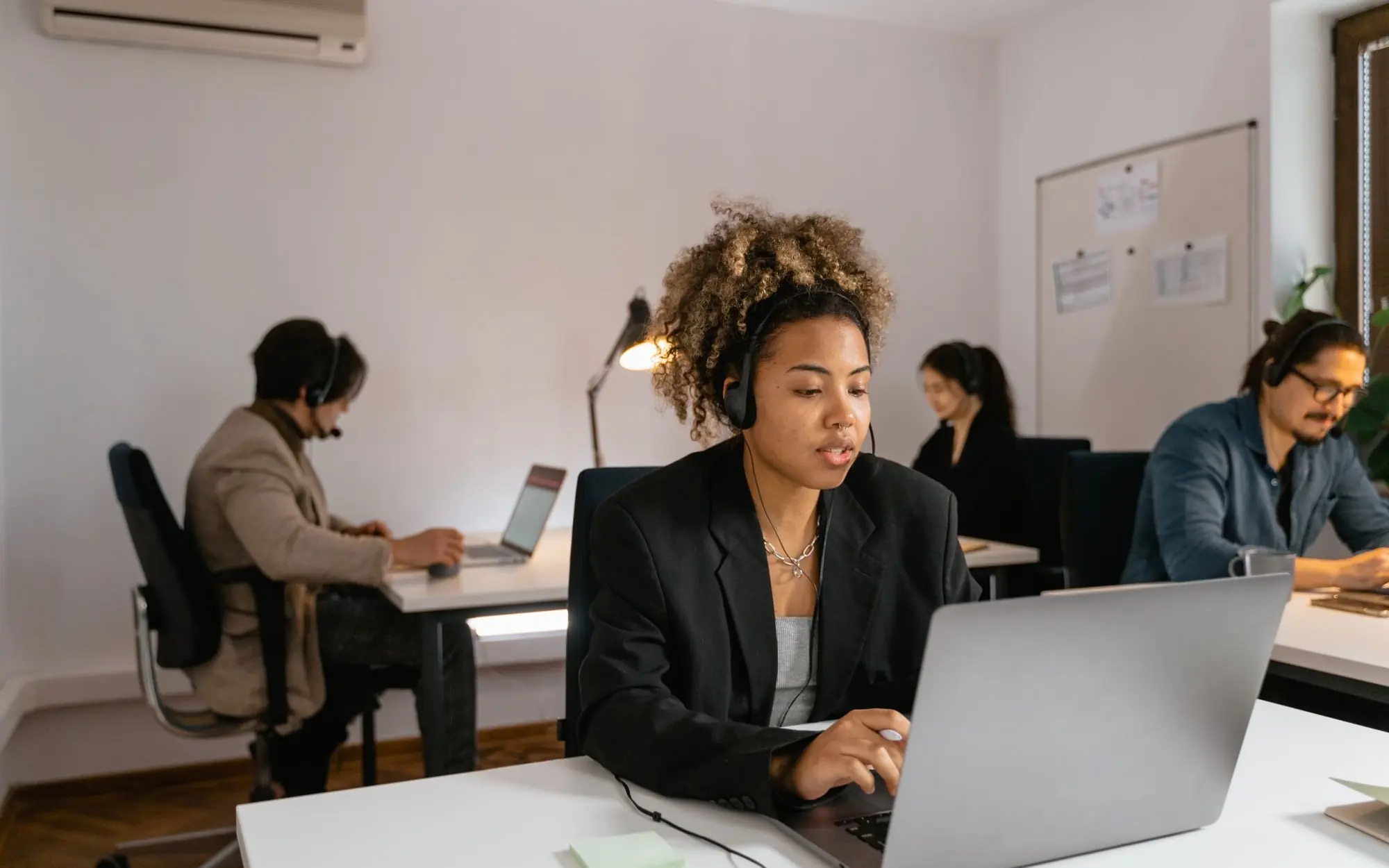 People working in an office with laptops.