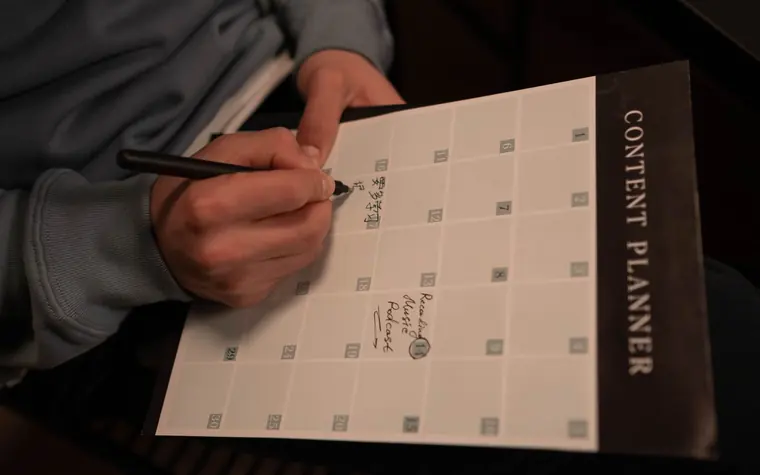 Person planning content on a laptop.
