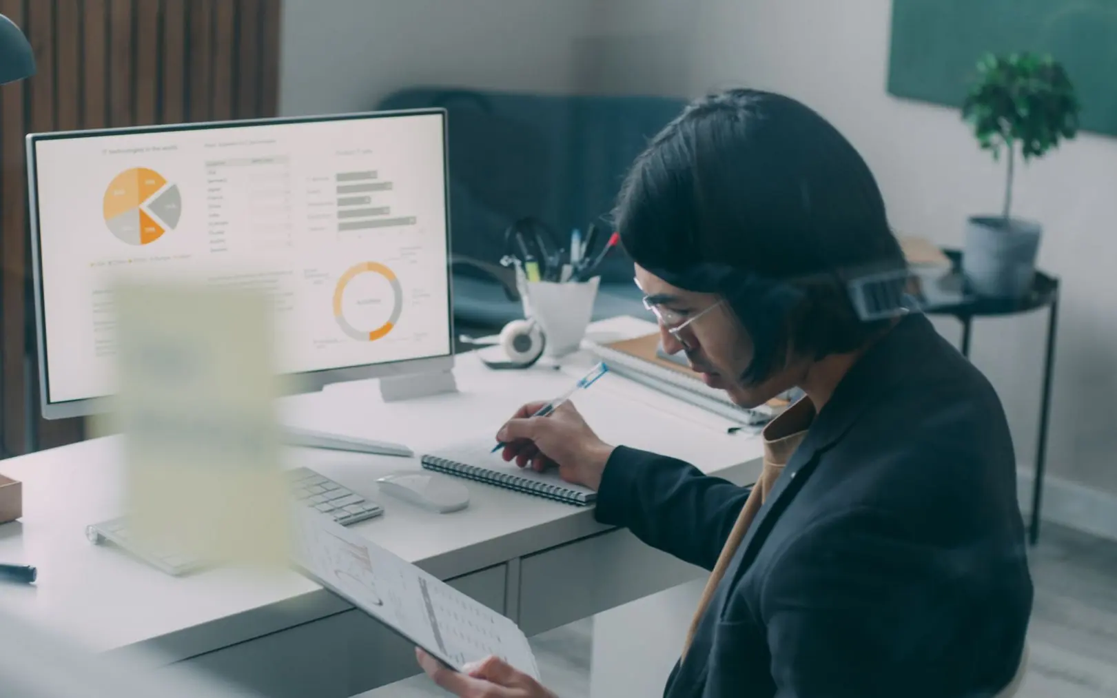 Marketer analysing performance charts at a desk.