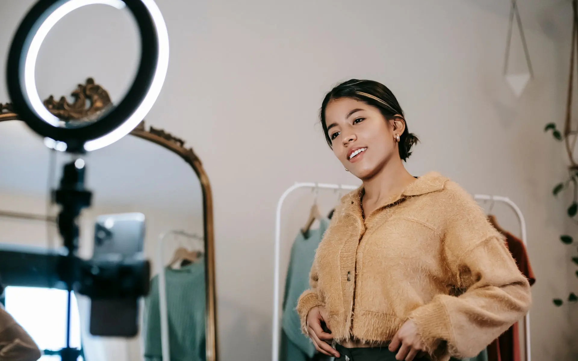 Content creator recording a video with a ring light.