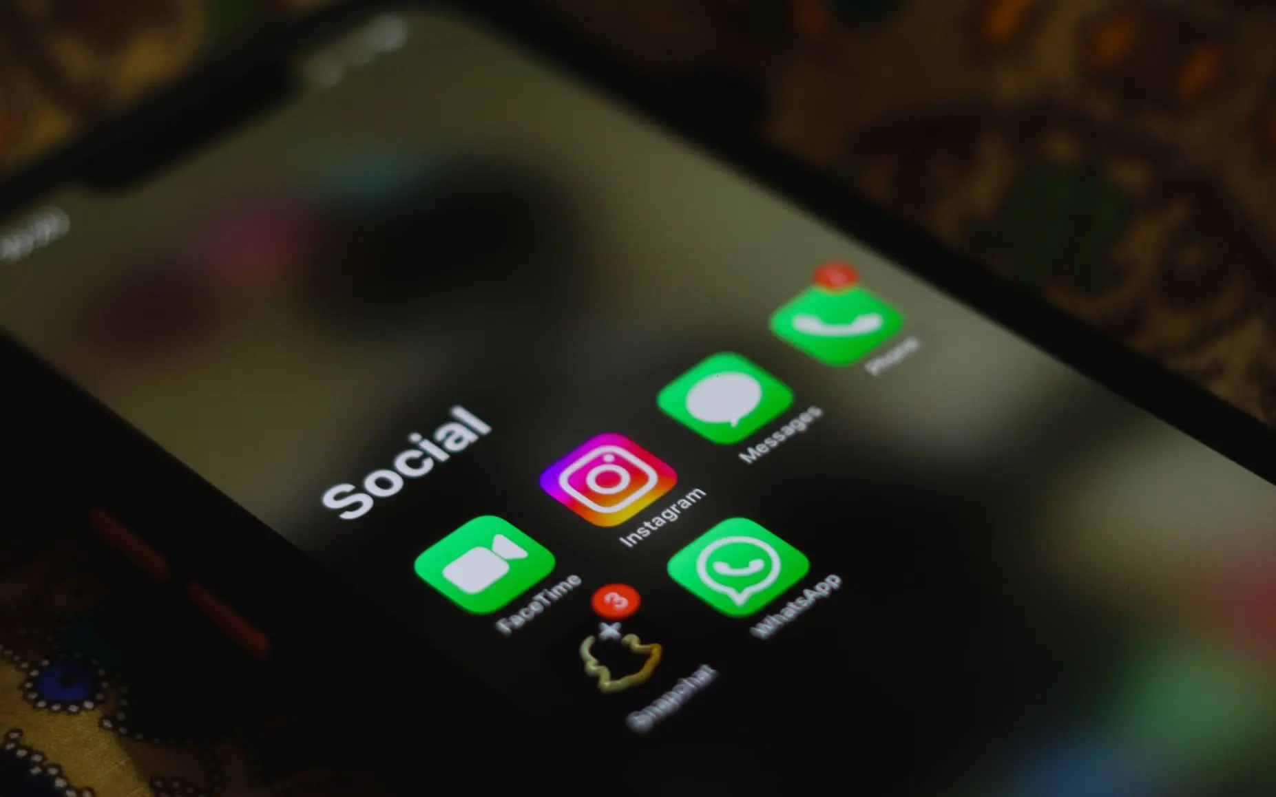 Social media app icons on a smartphone screen.
