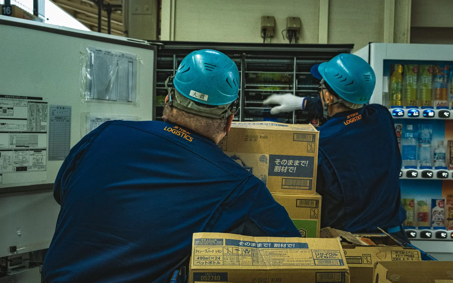 Worker scanning stocked products in a warehouse.