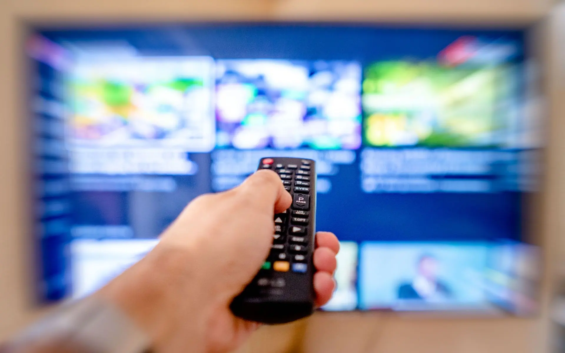 Person using a television remote.