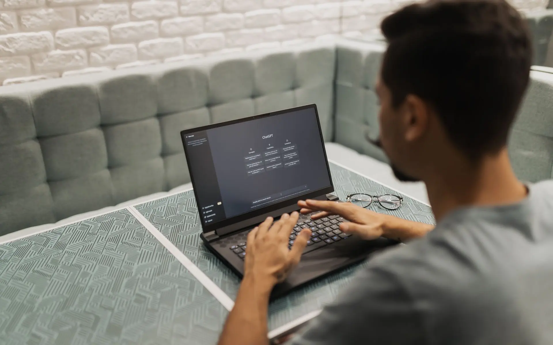 Man using ChatGPT on a laptop.