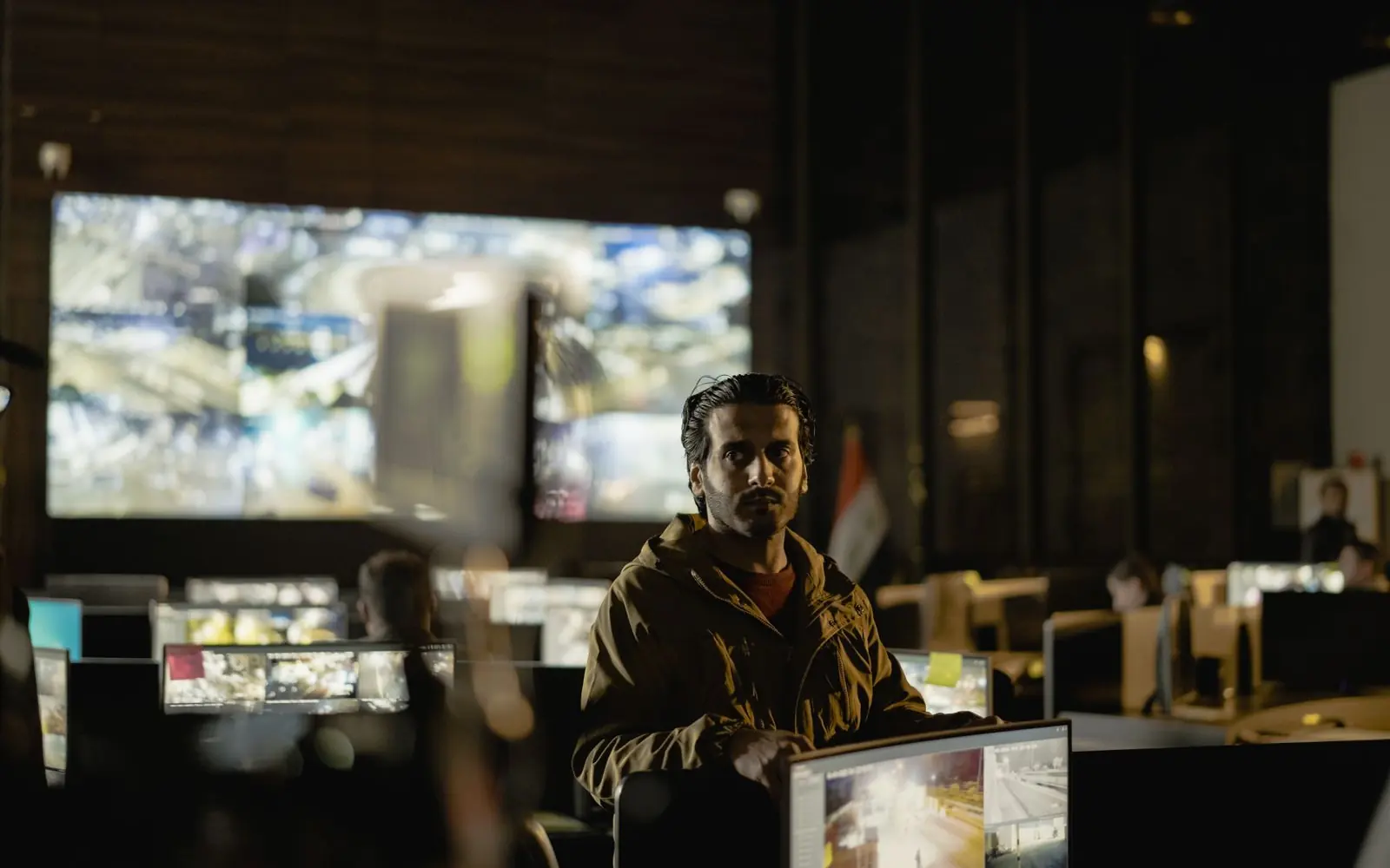 Security team monitoring live screens in an operations room.