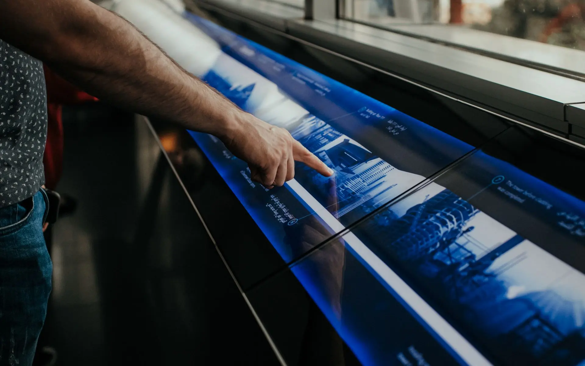 Person using a large interactive touchscreen.