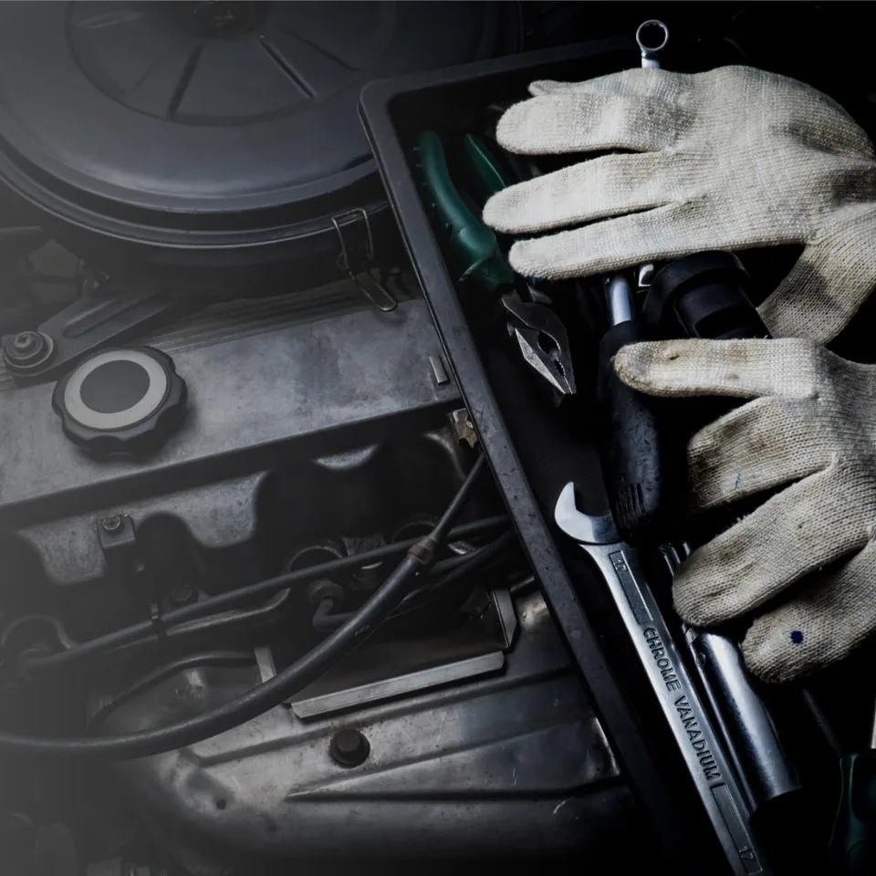 Automotive technician working on an engine.
