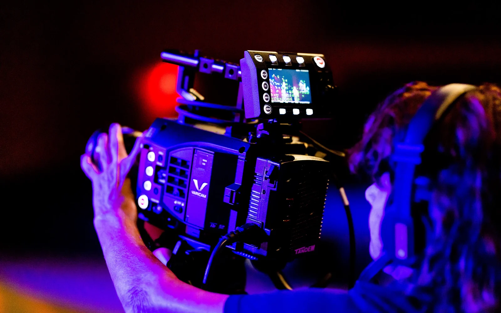 Camera crew filming a live production.