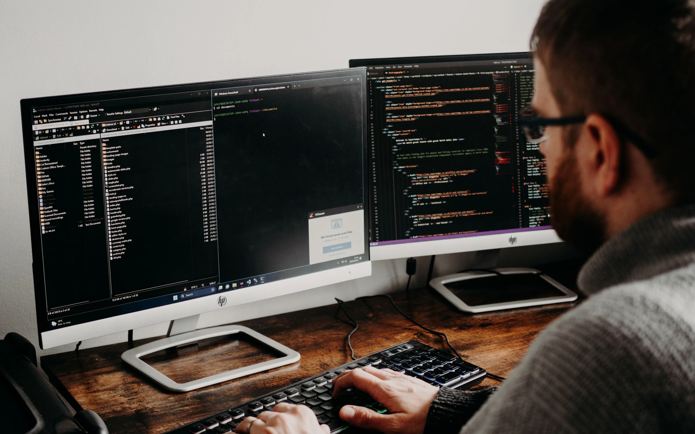 Developer working across two code screens.