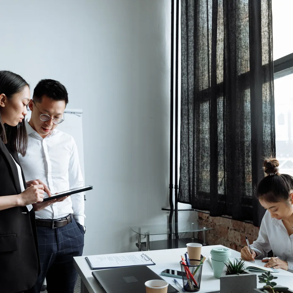 Two consultants reviewing a presentation in an office.