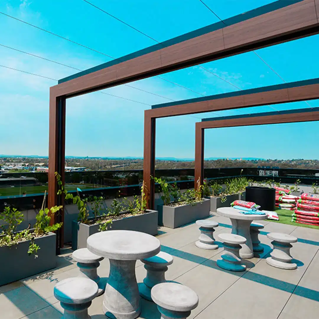 Outdoor seating beneath a timber pergola.