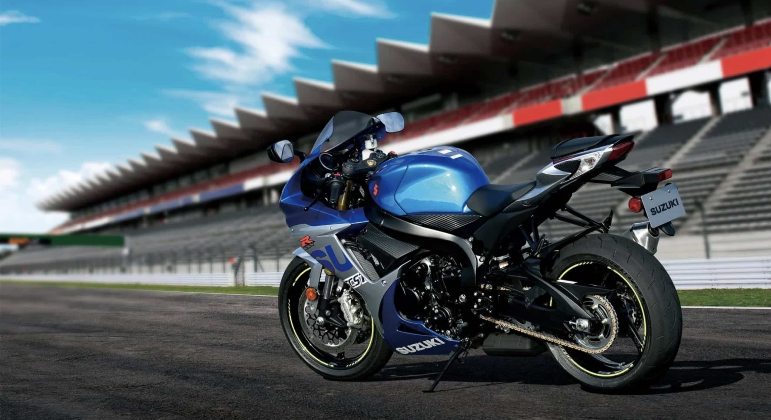 Blue Suzuki motorcycle on a racetrack.
