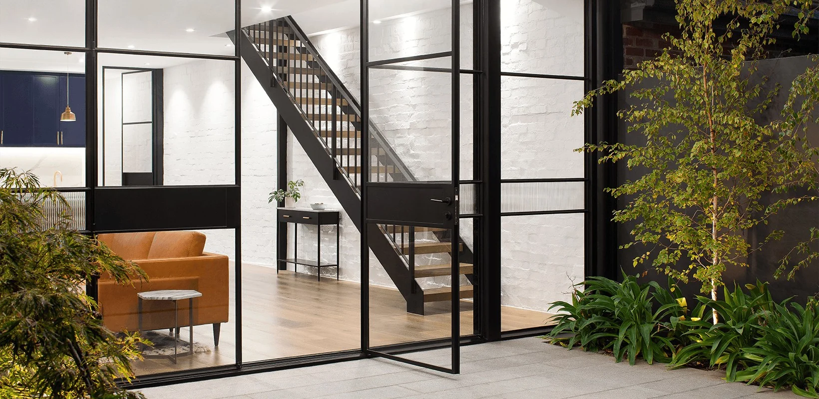 SWD, contemporary interior showcasing black steel-framed windows.