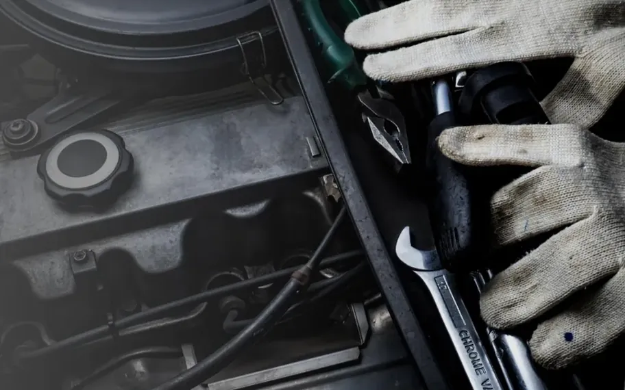 Automotive technician working on an engine.
