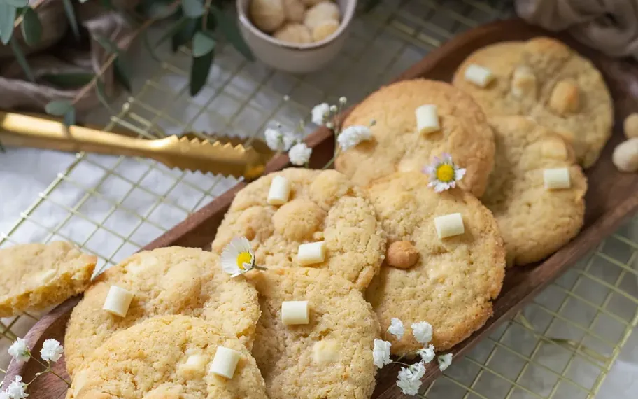 Macadamia cookies on a serving board.