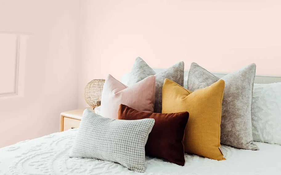 Newline cushions arranged in a home setting.