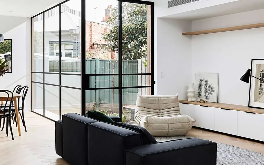 Bright modern interior with floor-to-ceiling windows.