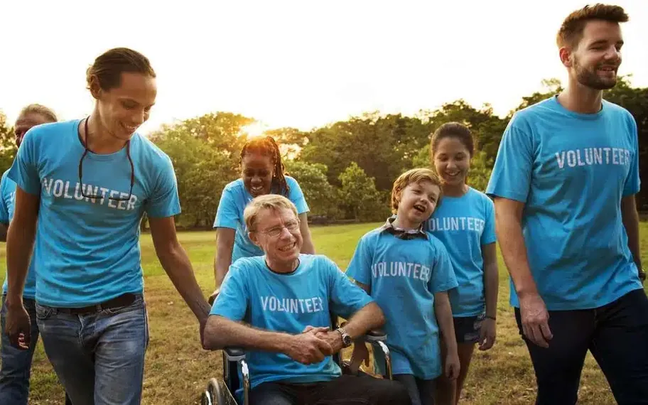 People in blue shirts outdoors.