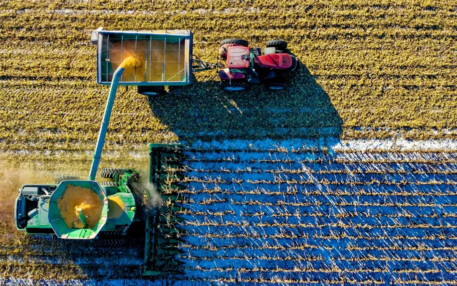 Agricultural machinery harvesting a crop.