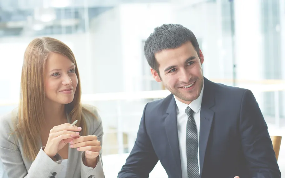 Recruitment consultants meeting with a candidate at a table.