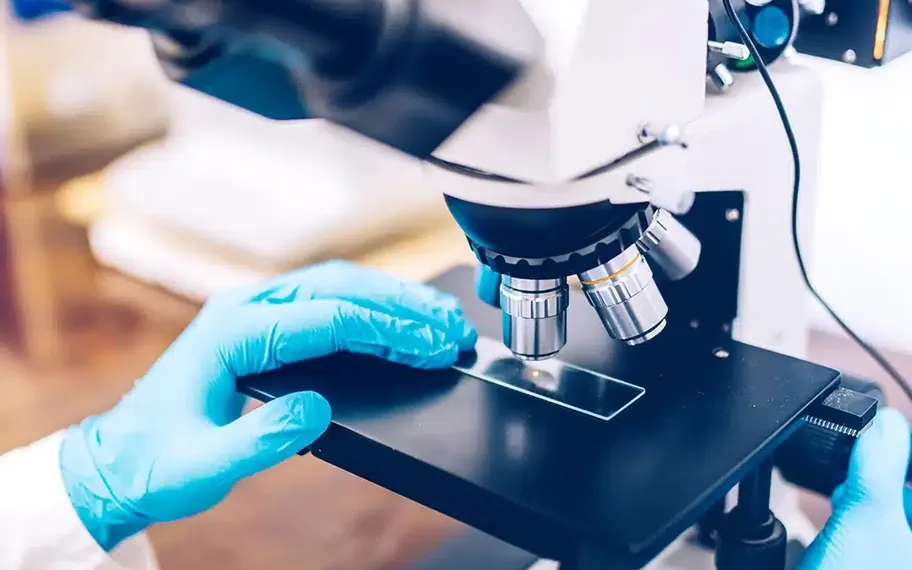 Scientist preparing a microscope sample.
