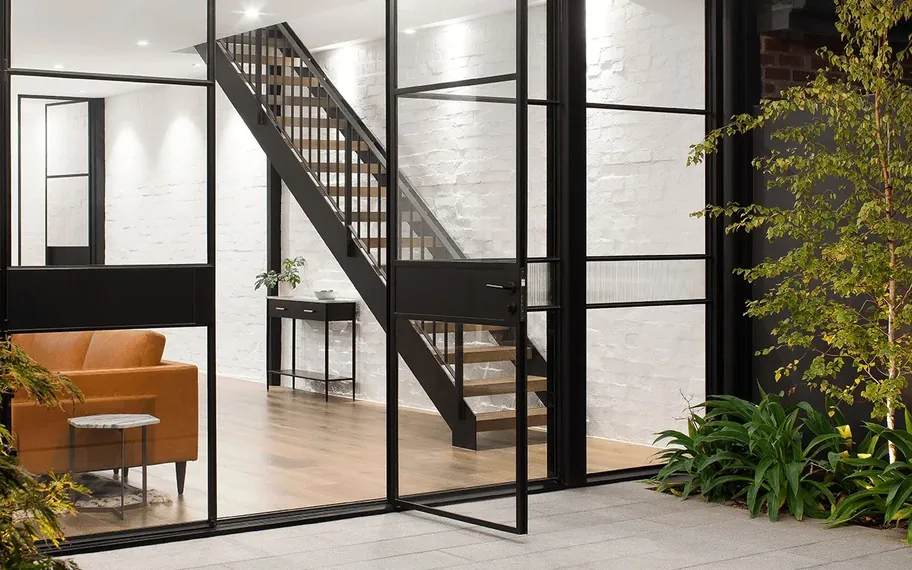 SWD, contemporary interior showcasing black steel-framed windows.