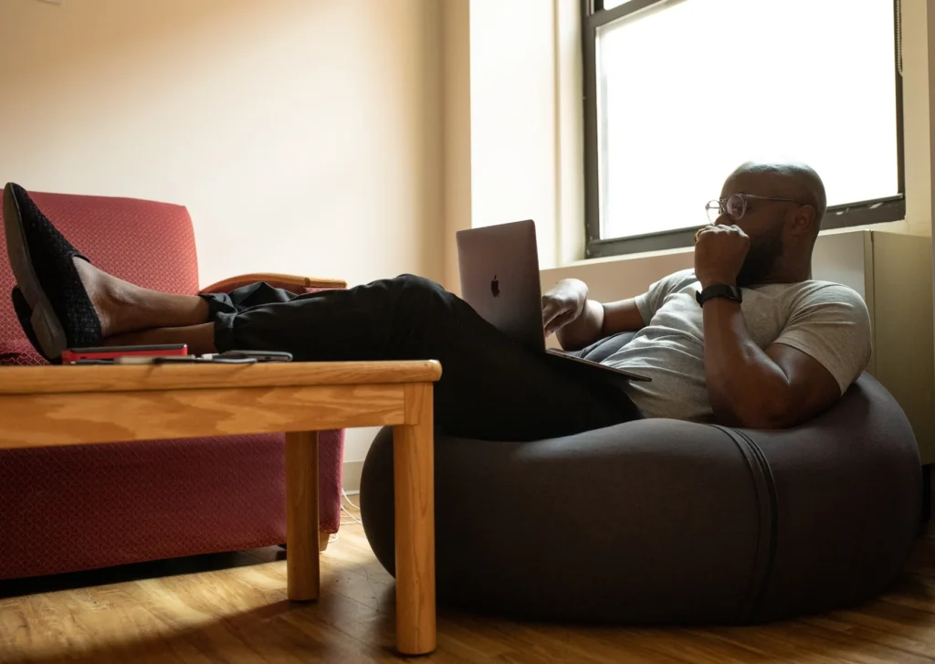 Man Working Leisurely on Couch
