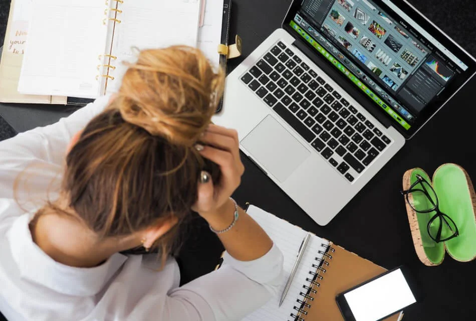 Female Marketing Stressed Over Work Desk